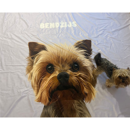 A soft blanket featuring a large, detailed illustration of a Yorkshire Terrier named "Bendžijs" with a fluffy tan coat and dark eyes, set against a periwinkle background, with a smaller real Yorkshire Terrier partially visible in the background.