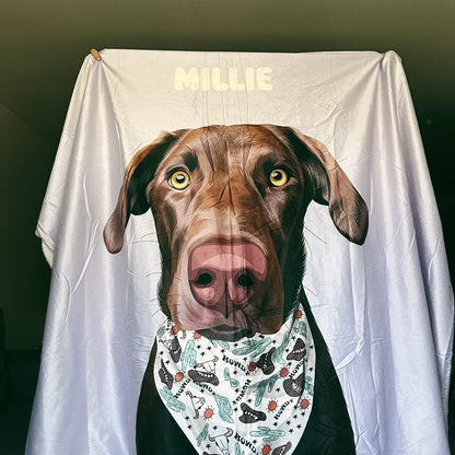 Product shot of a personalized periwinkle blanket featuring a Chocolate Lab-type dog illustration with a Western "HOWDY" bandana.