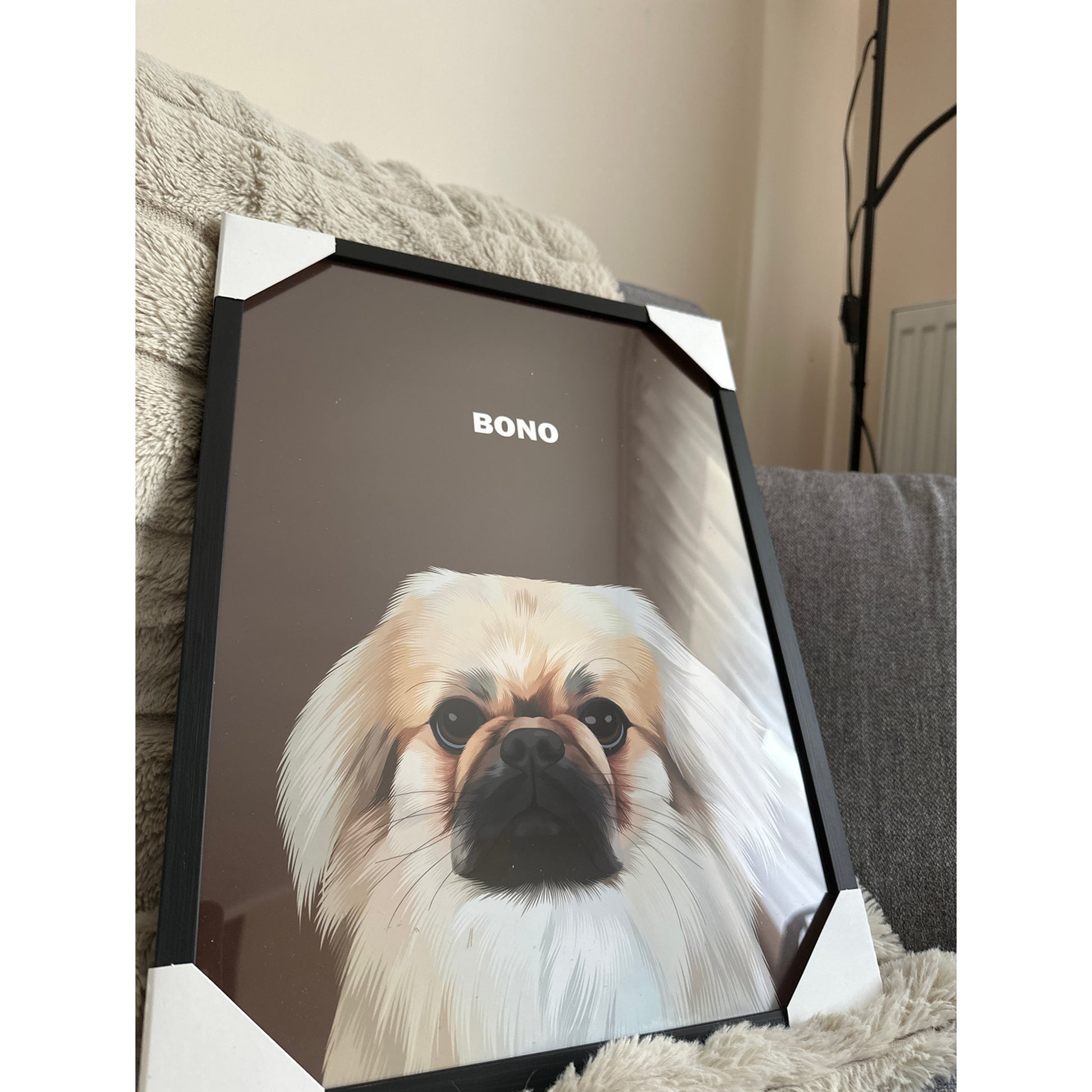 Close up photo of a custom pet portrait framed poster featuring artwork of a white dog called Bono