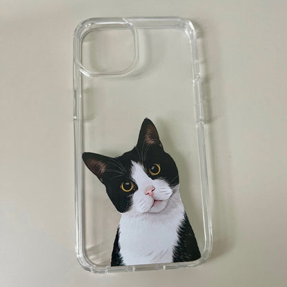 A clear phone case featuring an illustrated image of a black and white cat with striking yellow eyes, displayed on transparent iPhone 14 phone case