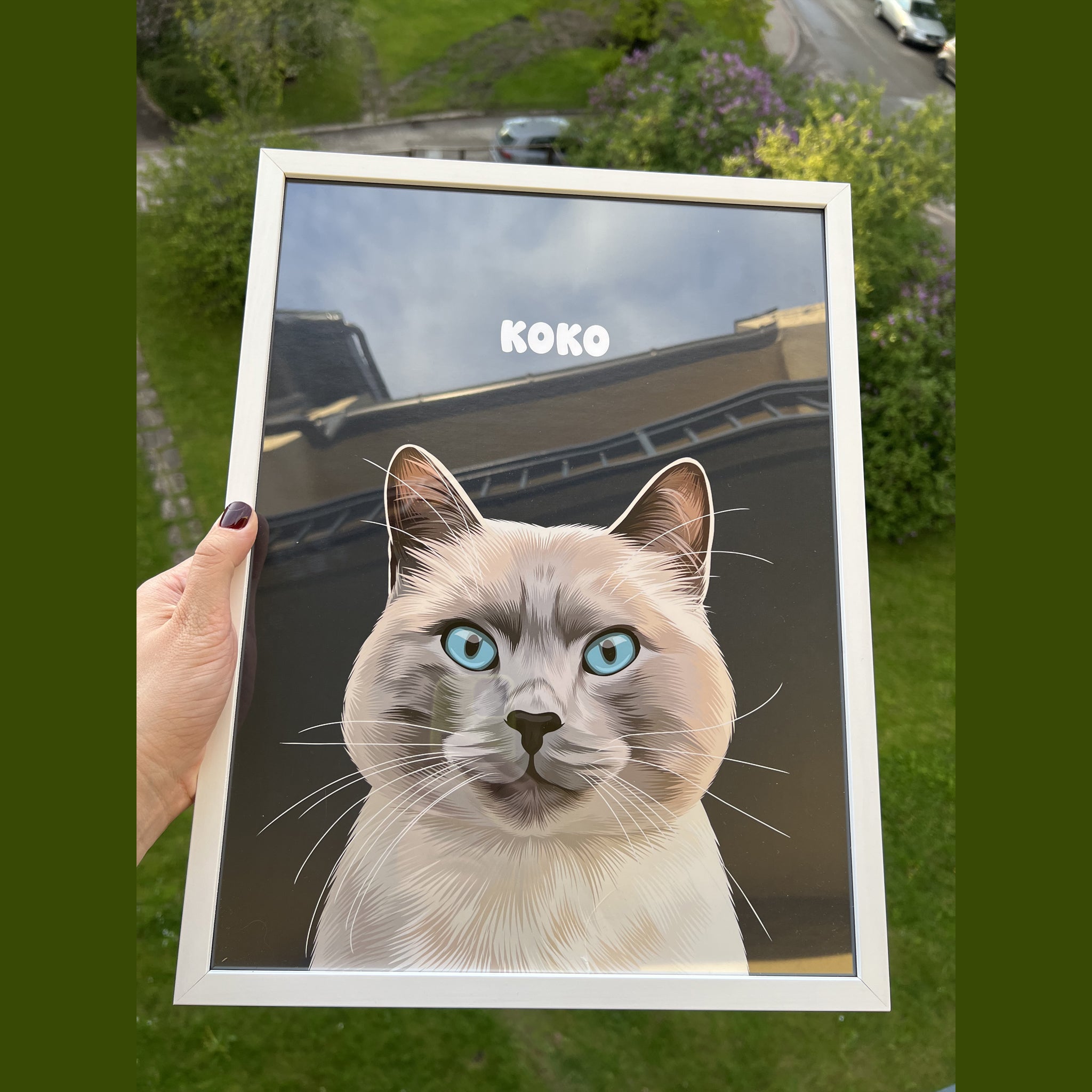 Close-up photo of a custom pet portrait framed poster featuring artwork of a white-grey cat