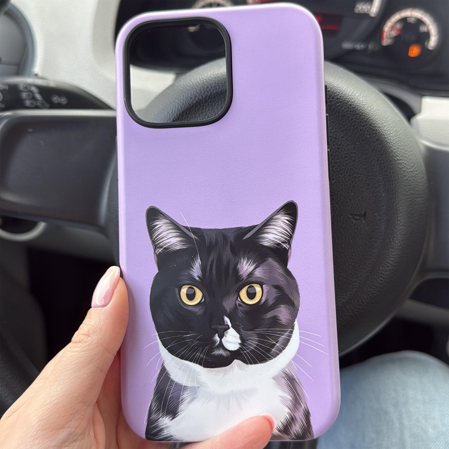 Close up photo of custom pet portrait tough phone case in purple color with black and white cat on the case.